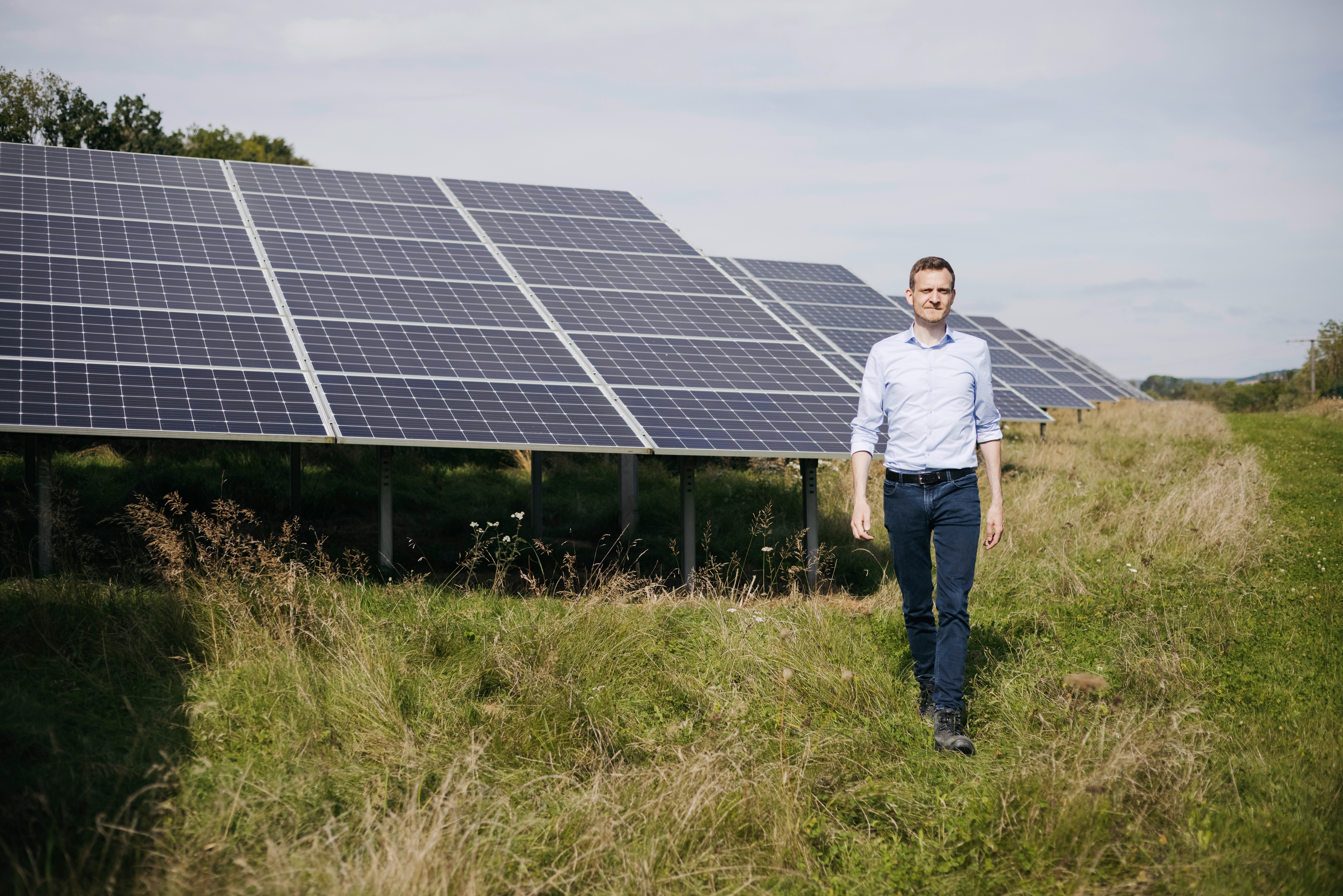 Mr. Engel (Netze BW) walking besides a solar park