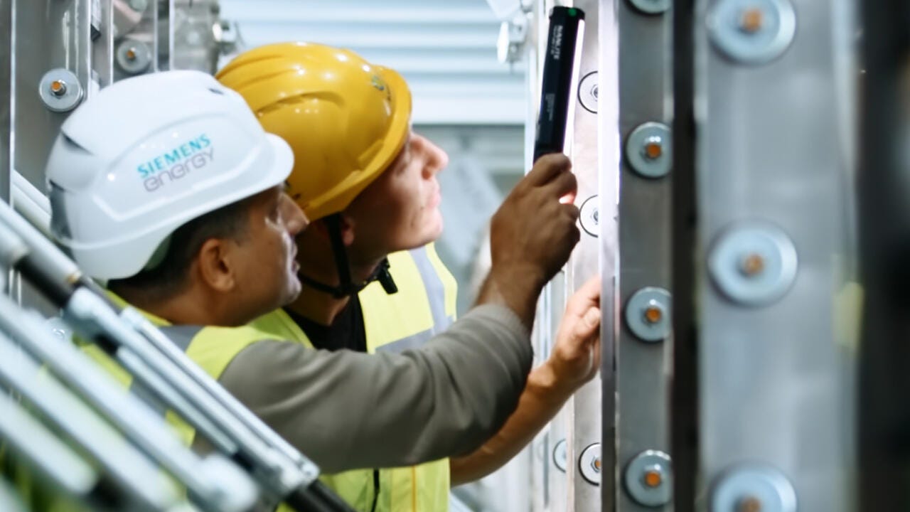 Two Siemens Energy technicians working on electrolyzers