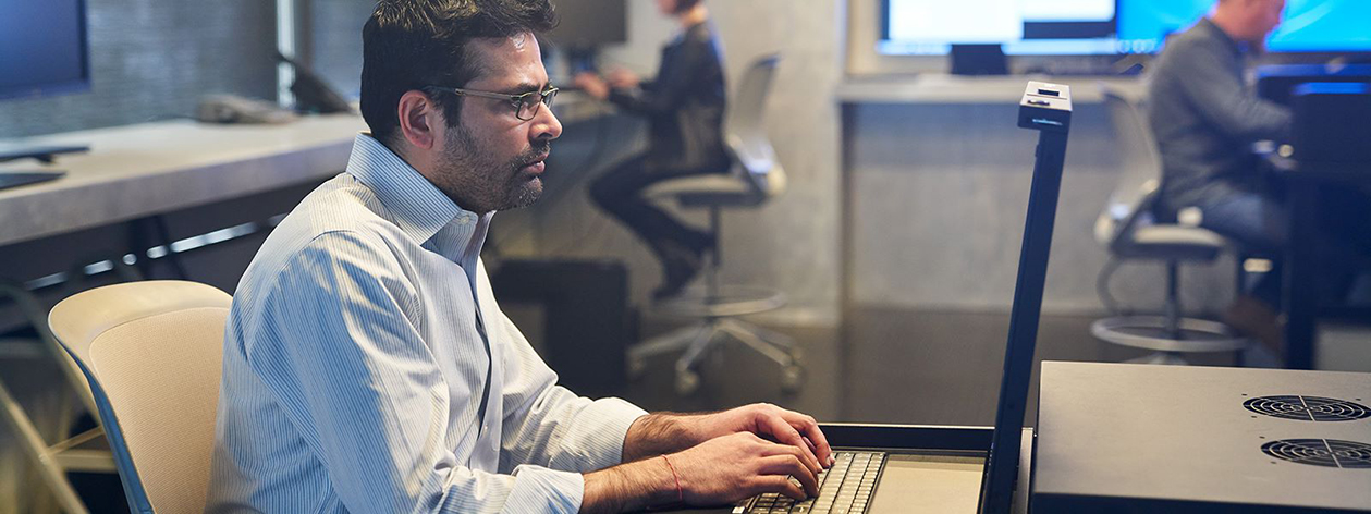 man working on secure laptop at desk