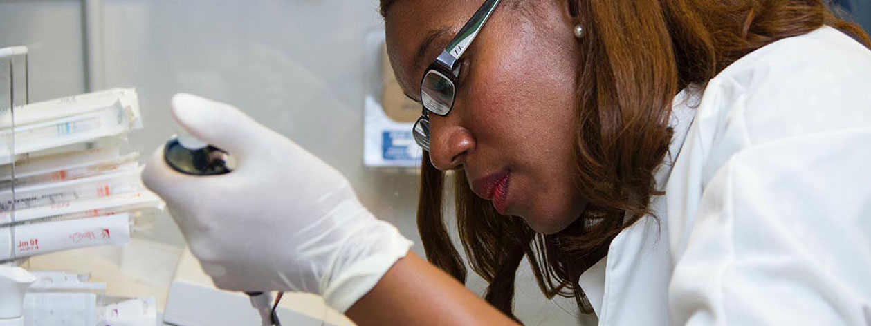 Scientist using a pipette in a biomedical laboratory