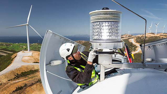 Service technician taking care of onshore wind turbine